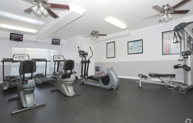 West Covina, CA Apartments - Tuscany Villas Fitness Center with Elliptical, Treadmills, Ceiling Fans, Large Window, and More