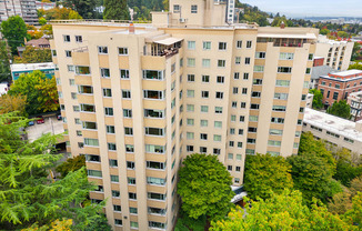 an aerial view of a large building surrounded by trees