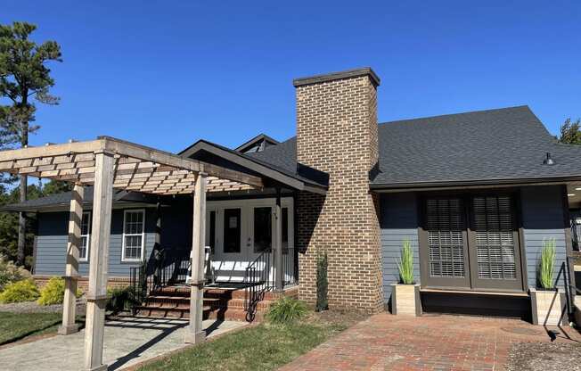 a house with a porch and a pergola