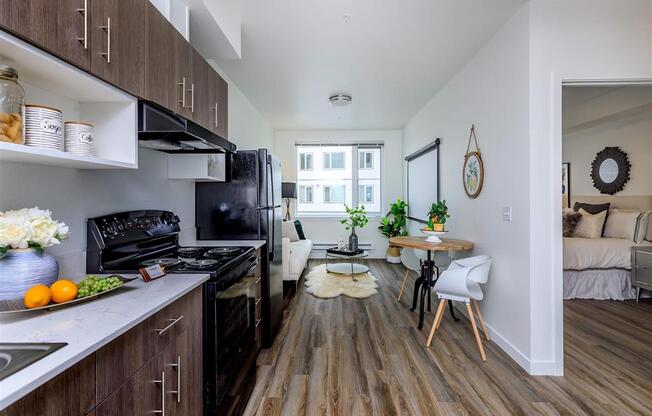 a kitchen with a stove top oven next to a window at Jefferson Yards, Washington