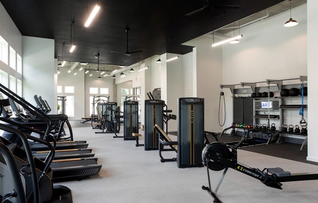 Club-Quality Fitness Studio with Climbing Wall, Peloton Bike, Yoga Studio, Rower, TRX, Cardio, Individual TV's + Weights