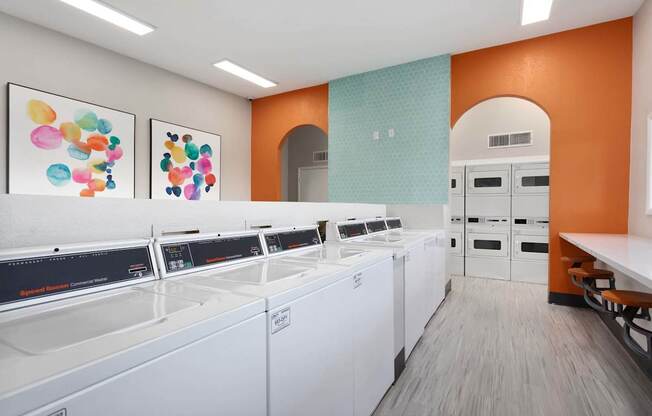 A row of washing machines in a laundromat.