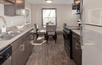 one plus den model, dining and kitchen with new slate cabinetry, stainless steel appliances