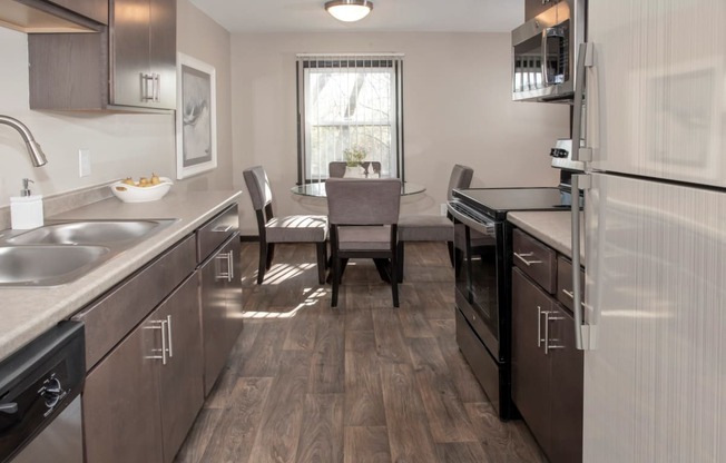 one plus den model, dining and kitchen with new slate cabinetry, stainless steel appliances