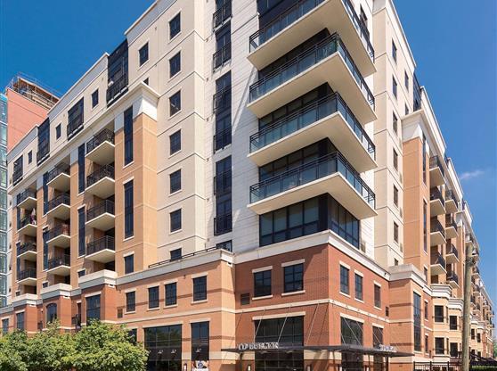 an apartment building with a courtyard in front of it