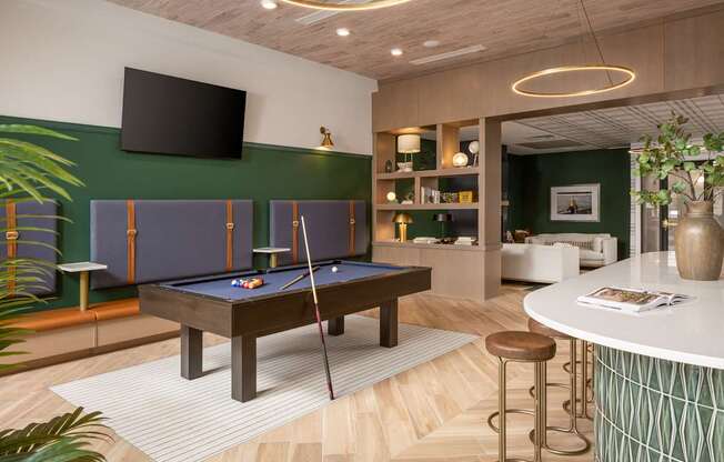 A room with a pool table and a bar.