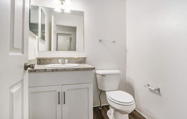 A white toilet sits in a bathroom next to a sink at Foxwood and The Hermitage, Portage, MI, 49024