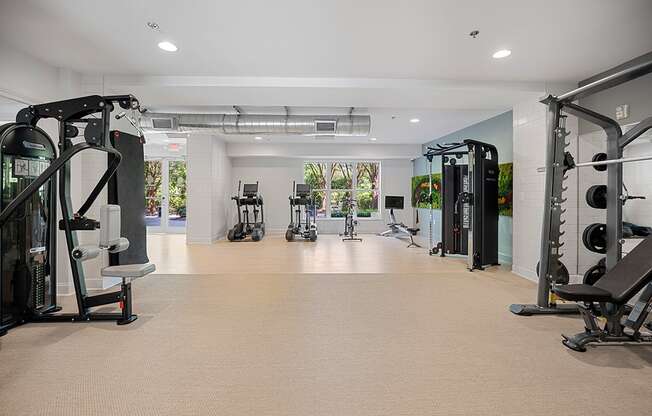 A spacious gym with various exercise machines and equipment.