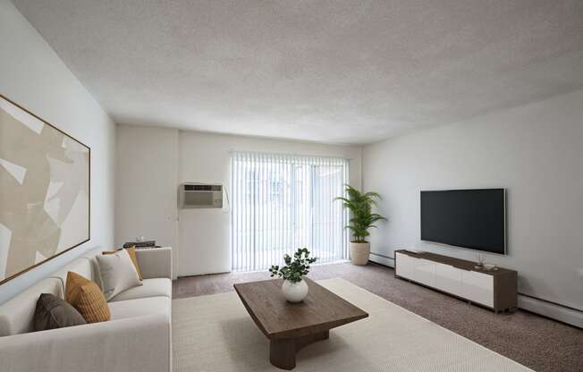 a living room with a couch and a coffee table. Coon Rapids, MN Robinwood Apartments