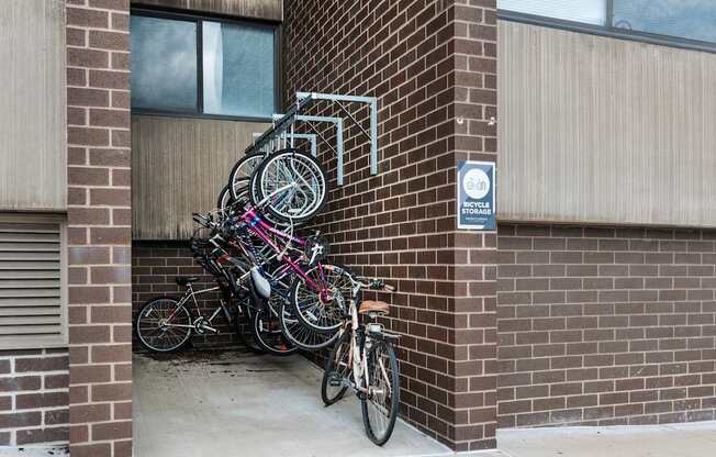 A bunch of bicycles are parked on a bike rack.