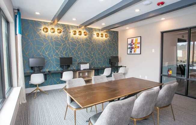 A conference room with a long table and chairs.