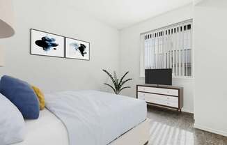 A bedroom with a bed, a television, and two framed pictures on the wall.
