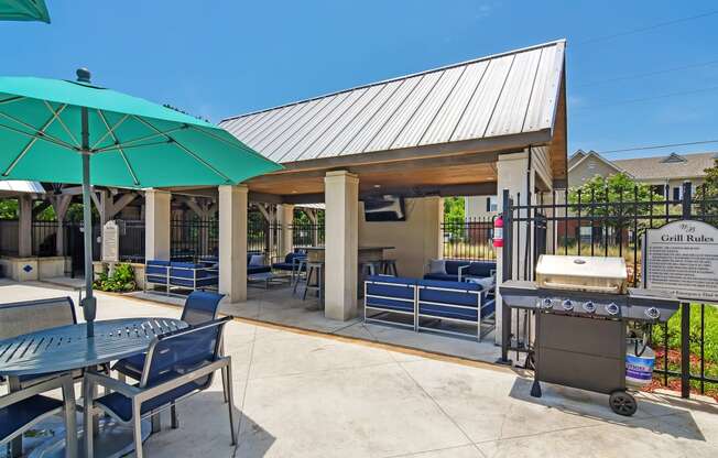 our patio with a grill and seating area at our apartments