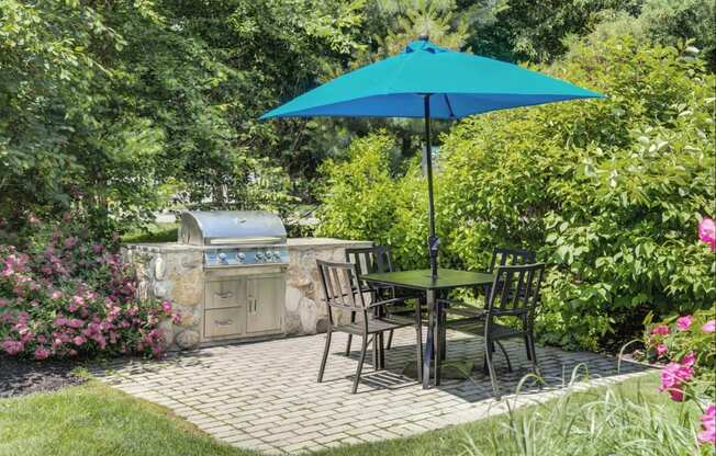 Outdoor grilling station with tables and grill