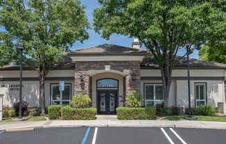 A clubhouse with a parking lot in front of it at Stoneridge Apartments, California, 95661