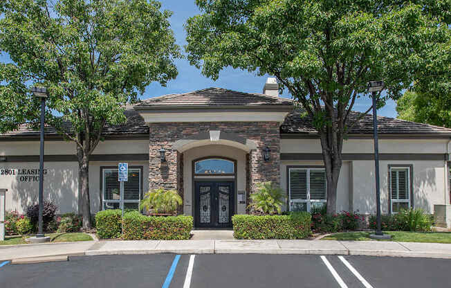 A clubhouse with a parking lot in front of it at Stoneridge Apartments, California, 95661
