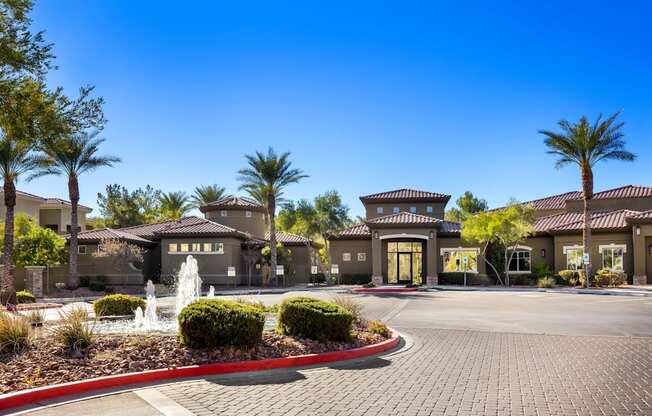 A building with a fountain in front of it. at The Fairways by Picerne Apartments, Las Vegas, NV, 89141