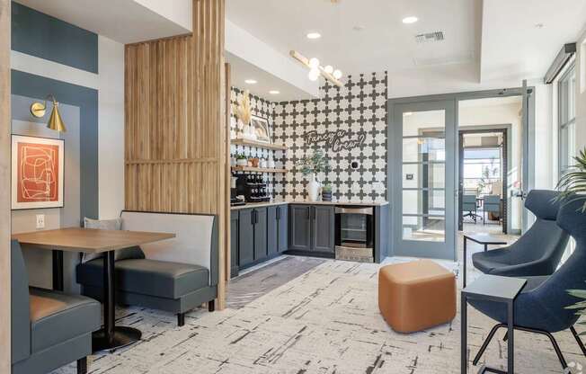 A modern interior with a wooden bar and grey chairs.