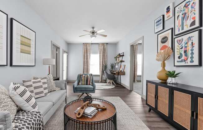 a living room filled with furniture and a ceiling fan at the Vue apartments in Indianapolis
