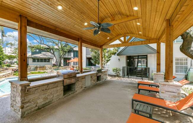 a covered patio with a bar and a pool