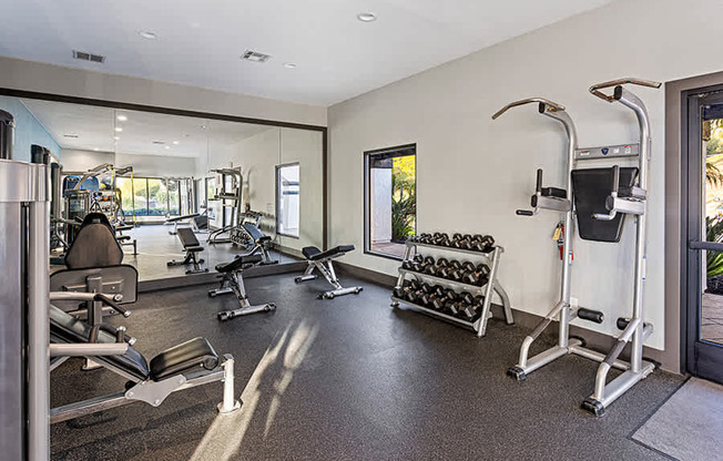 A spacious gym with a variety of equipment including treadmills, weights, and exercise machines.