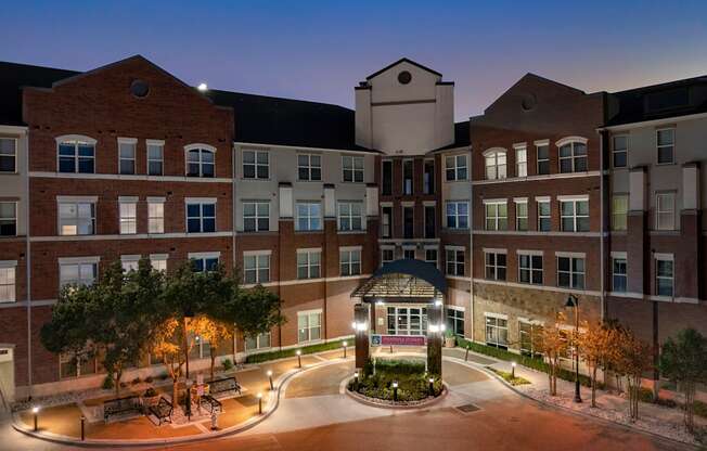 a large building with a fountain at night