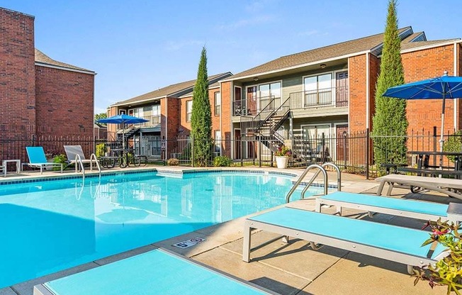 a large swimming pool with some chairs around it