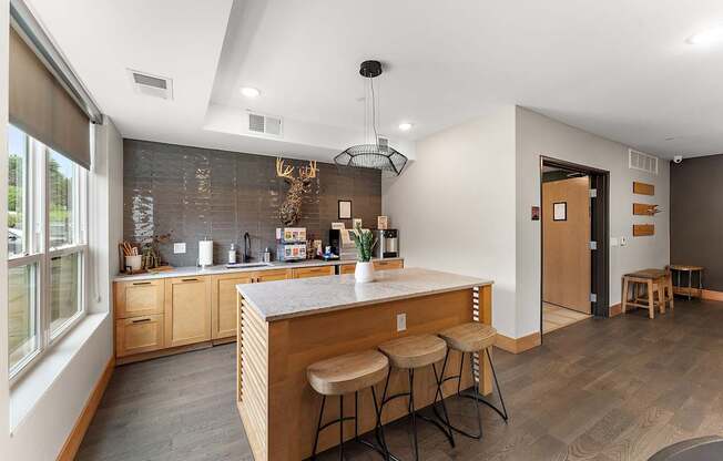 A kitchen with a bar stool and a counter.