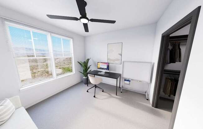 A room with a ceiling fan, a bed, and a window overlooking the beach at Refinery at Pointe17 Apartments, Arizona, 85085