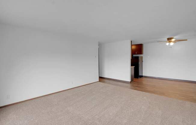 a bedroom with white walls and a beige rug