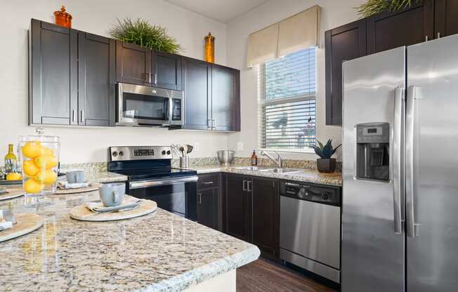 a kitchen with stainless steel appliances and granite counter tops