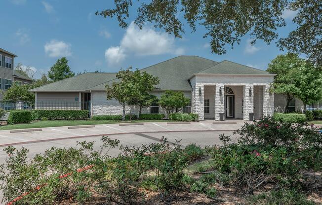 a house with bushes in front of a building