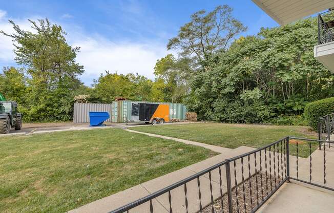 A metal fence surrounds a concrete patio.