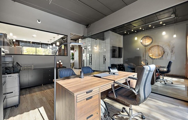 a modern office with a desk and chairs at Troy Place Apartments - Troy, MI, Troy, 48084