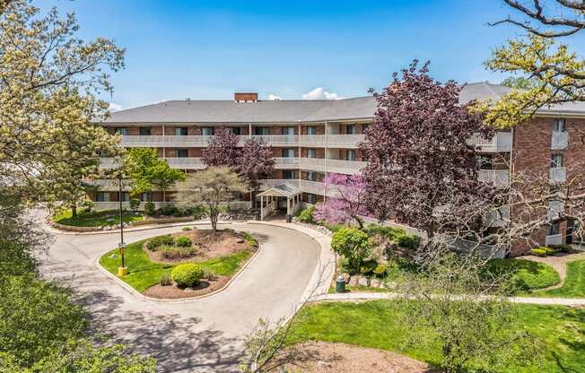 A large building with a green lawn in front of it.