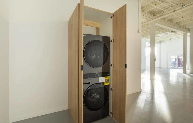 a washing machine in a doorway in a white room