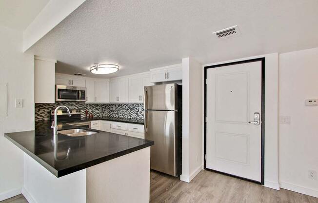 a kitchen with a refrigerator freezer and a sink  at Masselin Park West, California, 90036