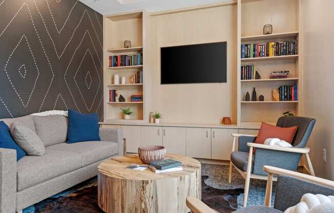 a library room filled with furniture and a flat screen tv at The Lodge at Overland, Rochester, MN, 55901