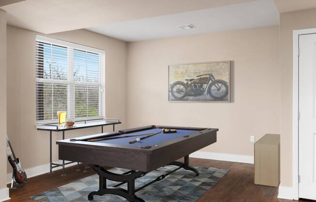 a game room with a pool table and a bike on the wall