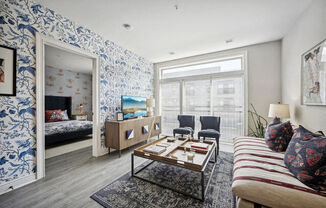 a living room with a couch and a table and a mirror