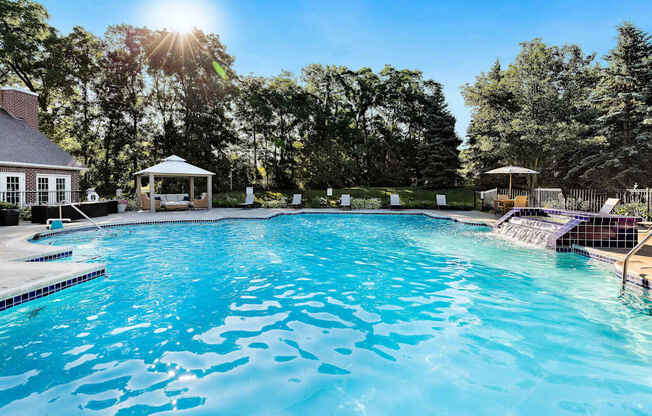 A large swimming pool with a gazebo in the background.