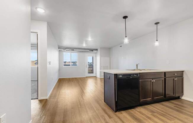 A kitchen with dark wood cabinets and a white countertop.