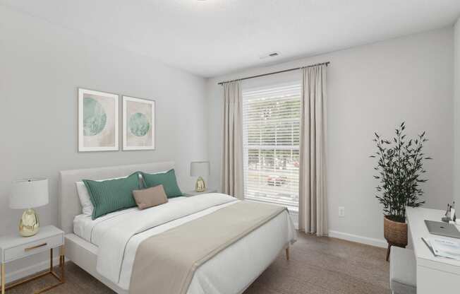 a bedroom with a white bed and green pillows