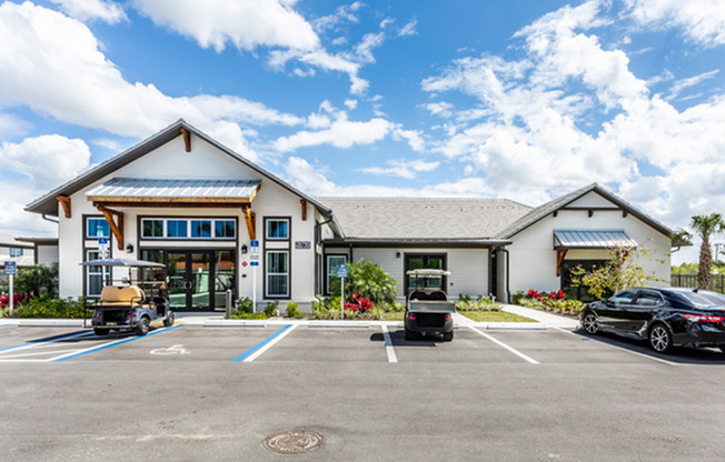 exterior leasing office with parking spaces in front in daytime