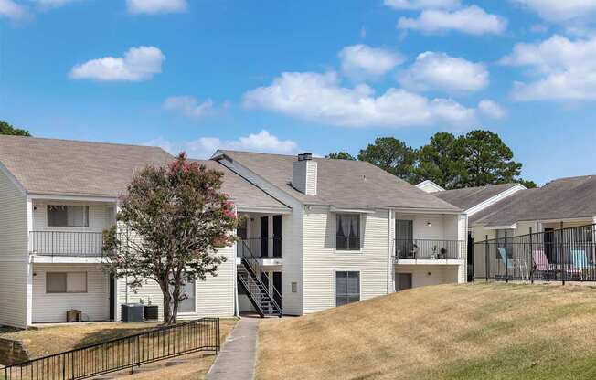A row of houses with a black fence in front.
