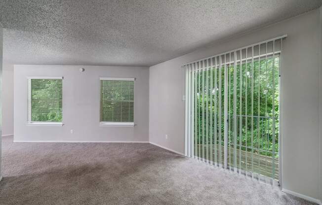 an empty living room with blinds and a window  at Shadow Ridge, Texas