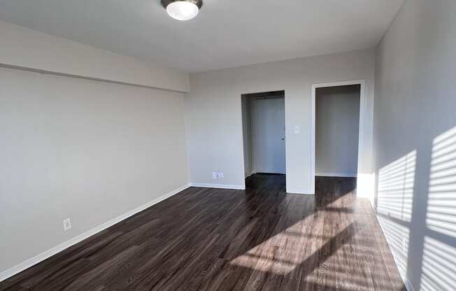 A room with wooden floors and white walls.