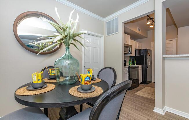 a room filled with furniture and vase of flowers on a table