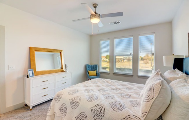 a bedroom with a large bed and a ceiling fan