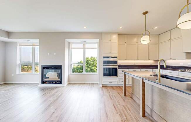 a large kitchen with a fireplace and a large island